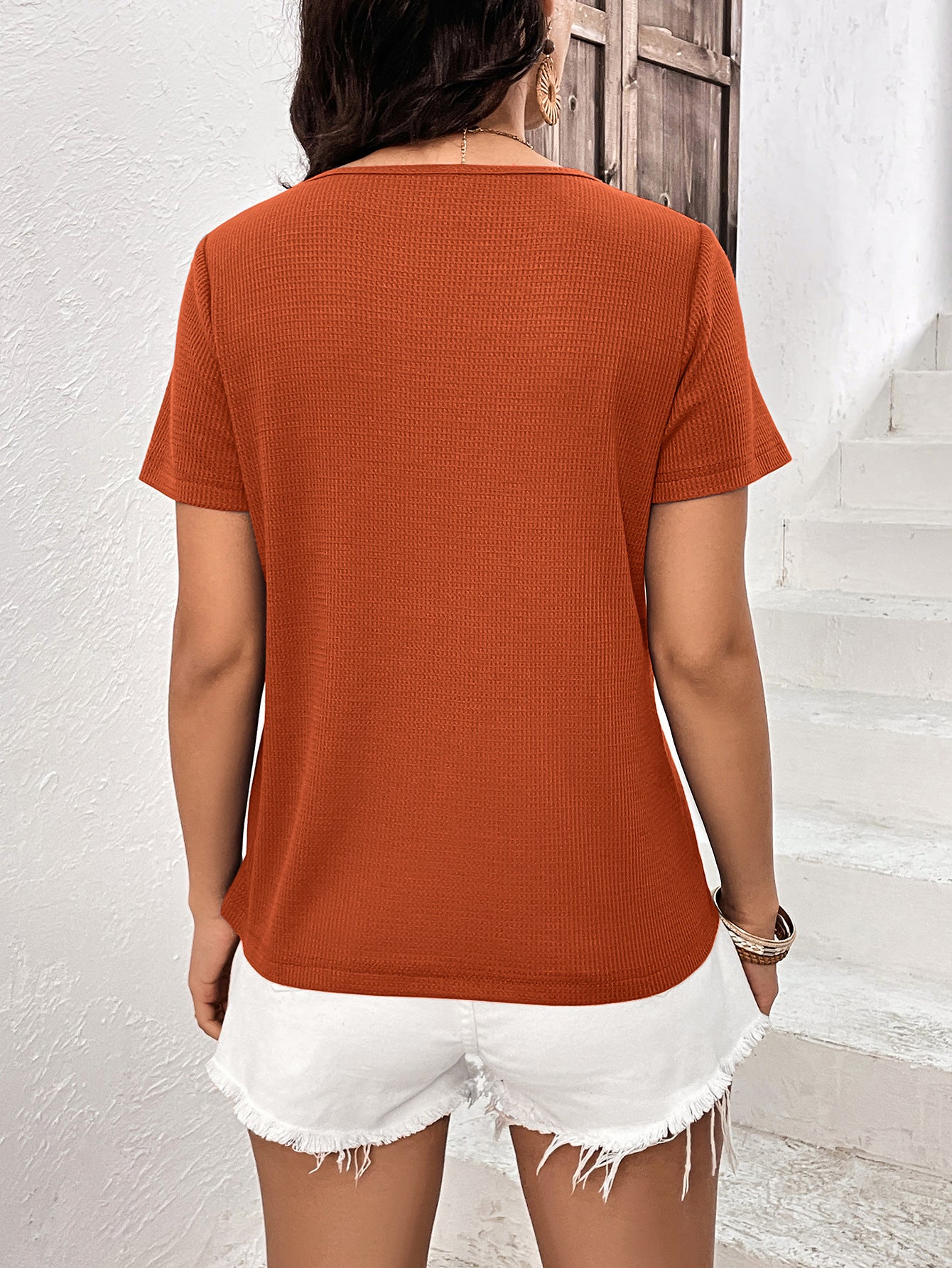 Orange-red waffle knit tee with short sleeves and a scoop neck.