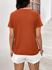 Orange-red waffle knit tee with short sleeves and a scoop neck.