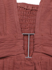 Plunging V-neck maxi dress in rust with smocked bodice and metal ring detail.