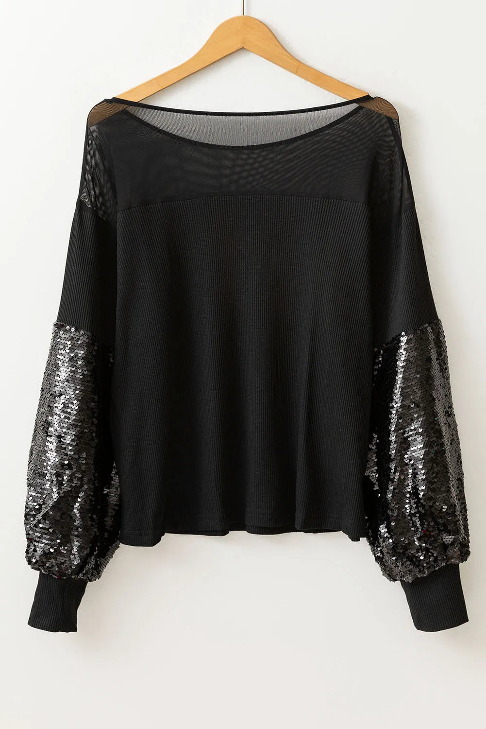 Black ribbed knit top with mesh yoke and sequin balloon sleeves.