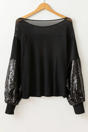Black ribbed knit top with mesh yoke and sequin balloon sleeves.