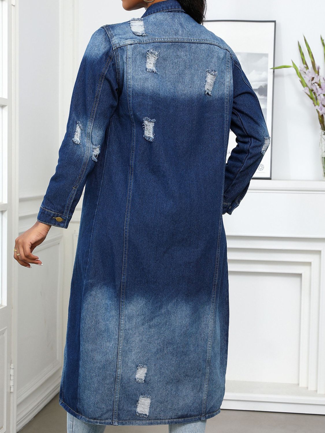 Distressed denim maxi jacket in medium wash with gold button detail and collared neckline.