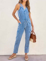 Acid wash cargo jumpsuit with drawstring waist and V-neck in medium blue.