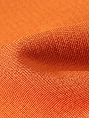 Orange long sleeve crew neck undershirt with ribbed texture.