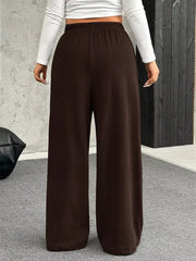 Brown maternity pants with wide legs and a drawstring waist, shown from the back.