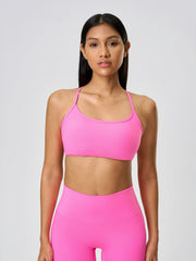 Strappy back active crop top in bright pink with a scoop neckline.