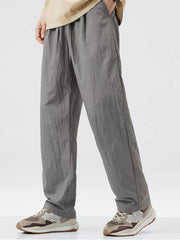 Relaxed fit wide-leg sweatpants in dark gray with drawstring waist and pockets.