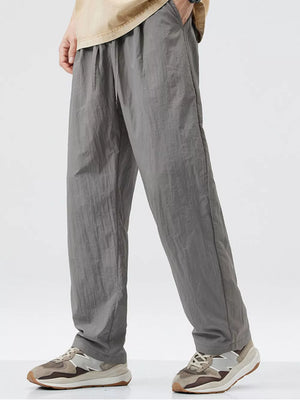 Relaxed fit wide-leg sweatpants in dark gray with drawstring waist and pockets.