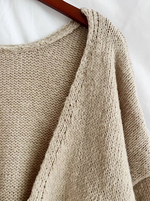 Khaki textured tie-front knit cardigan with open weave detail on shoulder.