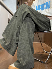 Men's green plaid loose fit sweatpants with drawstring detail.