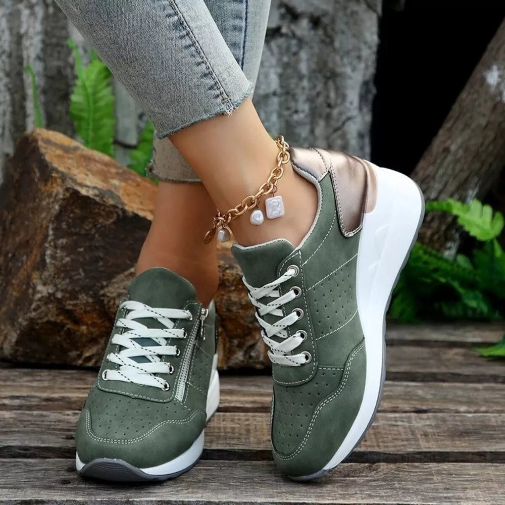 Dark green lace-up wedge sneakers with white laces and a side zipper detail.