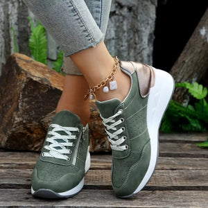 Dark green lace-up wedge sneakers with white laces and a side zipper detail.