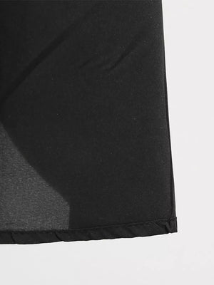 Black midi dress with lace-up detail and pockets, shown in a close-up of the fabric.