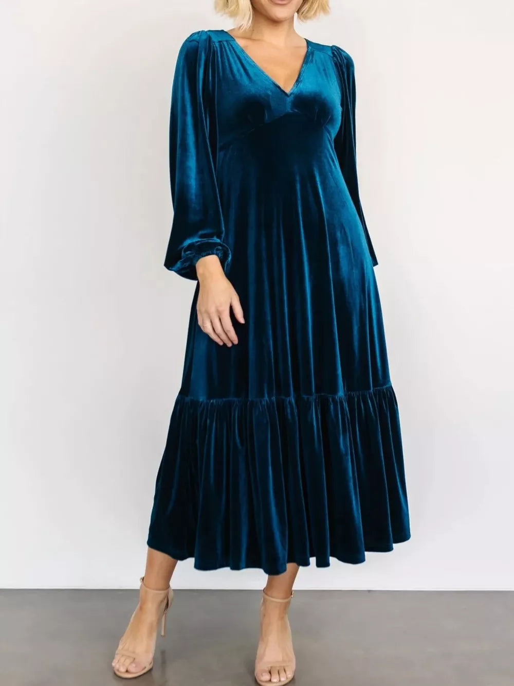 Peacock blue velvet midi dress with tiered skirt and bishop sleeves.