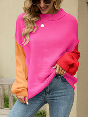 Colorblock drop shoulder knit sweater in hot pink, orange, and red acrylic with a mock neck.