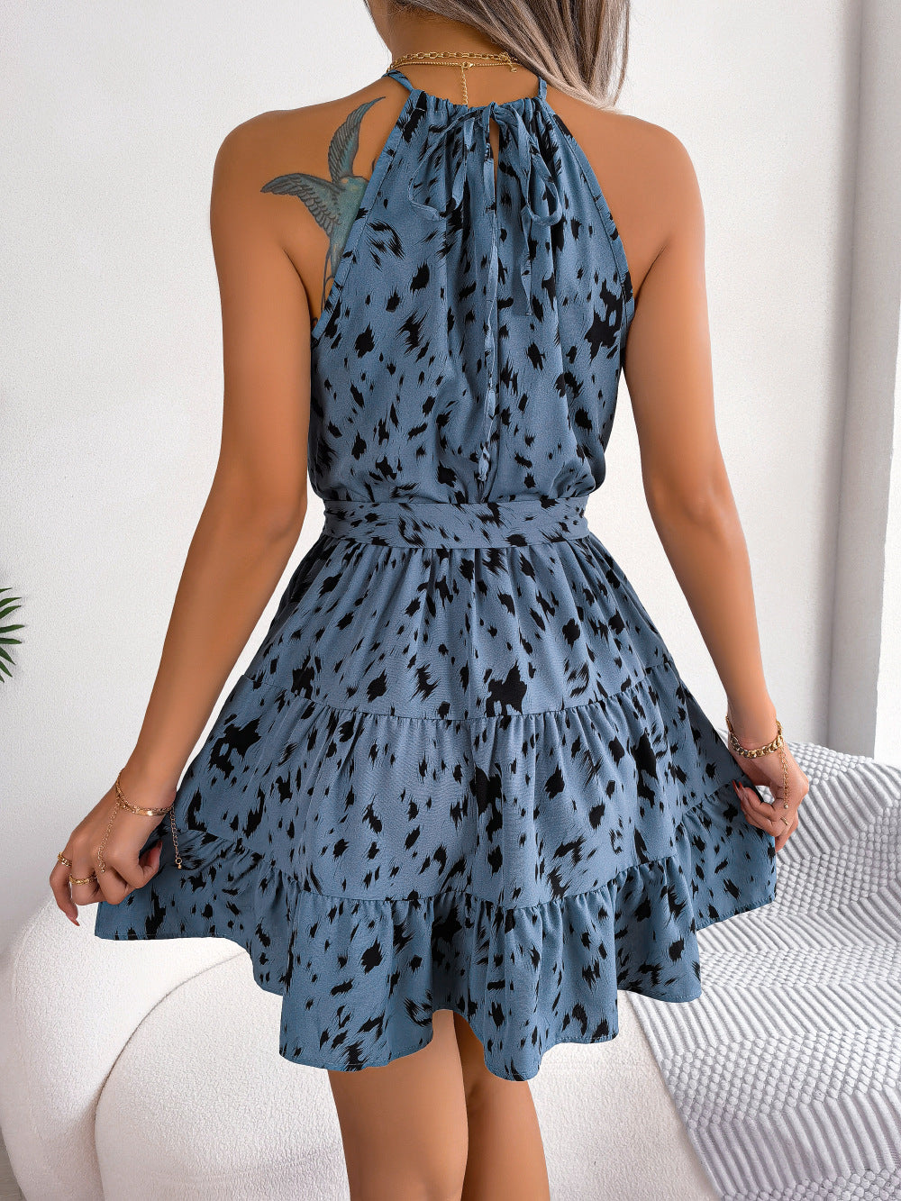Dusty blue halter mini dress with black animal print and tiered ruffle hem