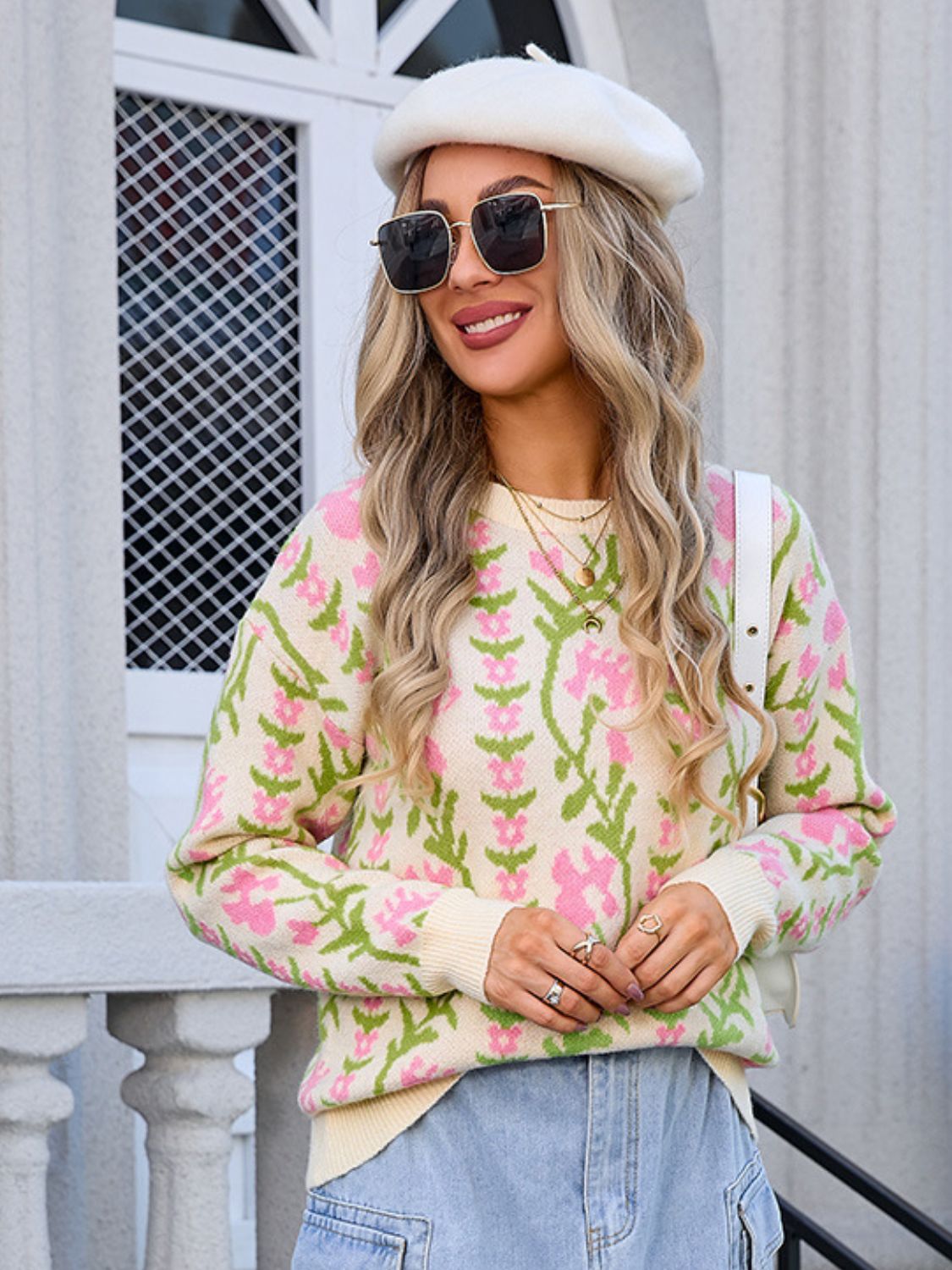 Floral tapestry crewneck sweater in pastel yellow with pink blooms and green stems, acrylic knit.