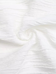 White textured maternity blouse with cap sleeves and bow detail
