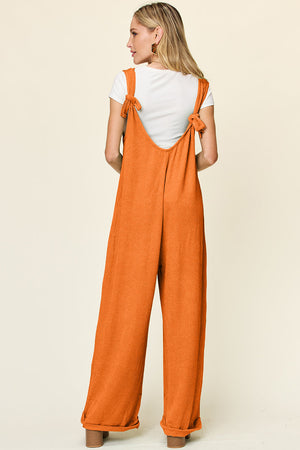 Ribbed knit jumpsuit in Tangerine with tie straps and wide legs.