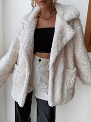 Cream teddy bear shawl collar jacket with pockets, styled open over a black tube top.