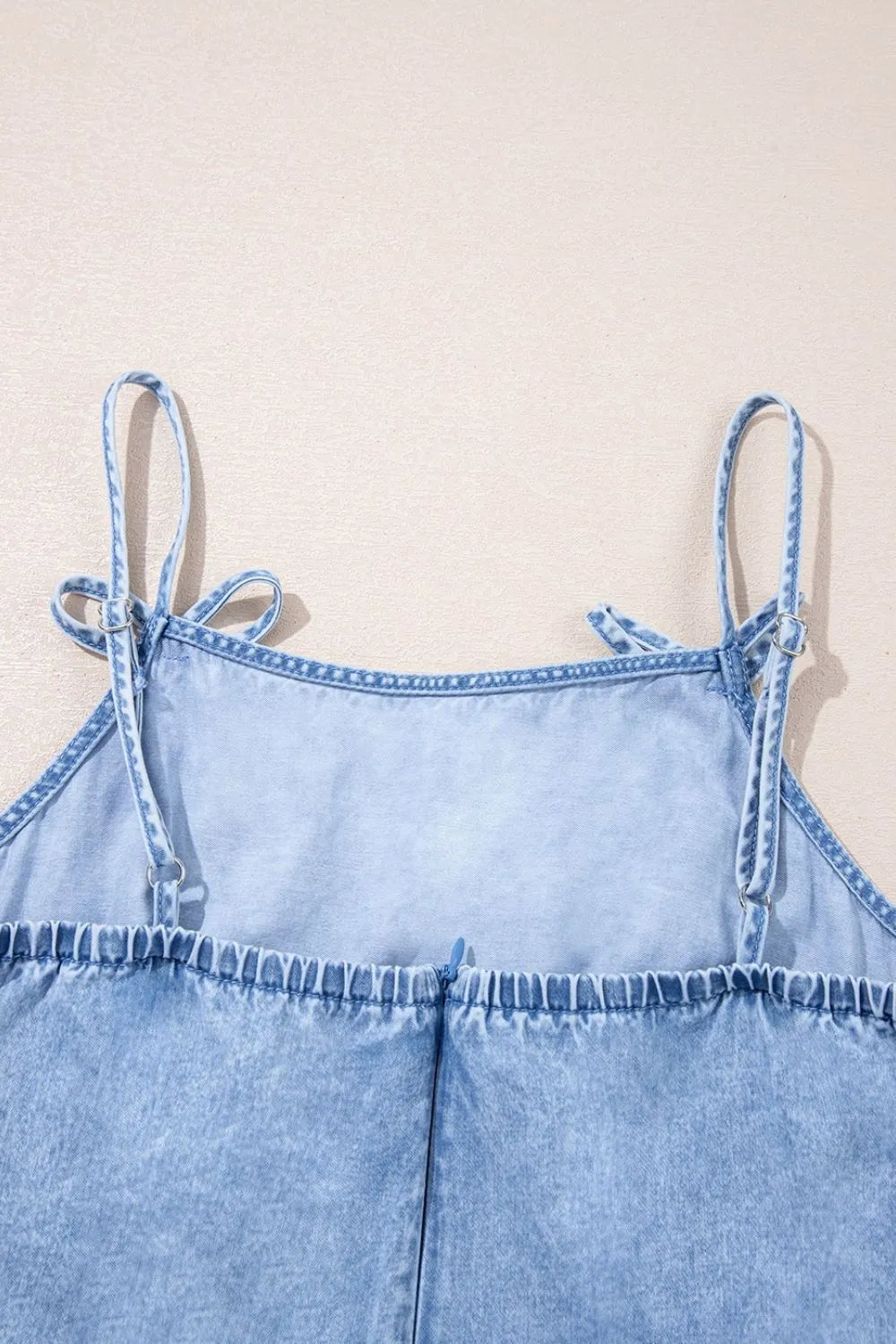 Light blue denim sundress with tie straps and ruffled hem detail