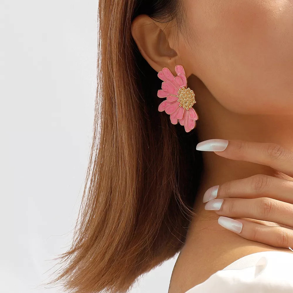 Textured pink flower stud earrings with gold center detail.