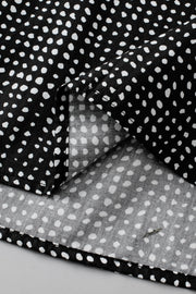 Black micro-dot puff sleeve blouse with a casual, basic style.