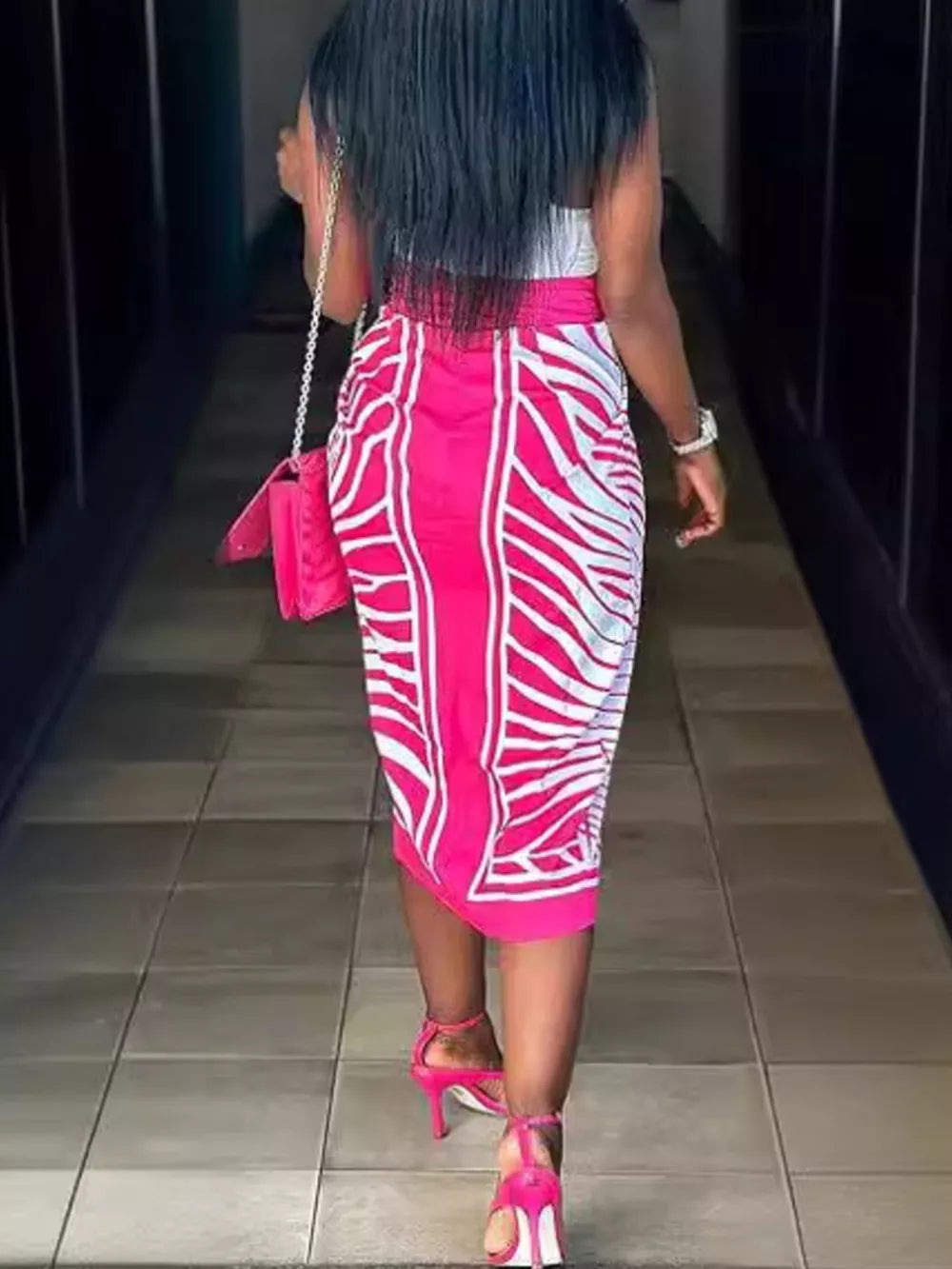 Rose Red midi skirt with white abstract pattern and side slit, featuring a twisted knot detail.