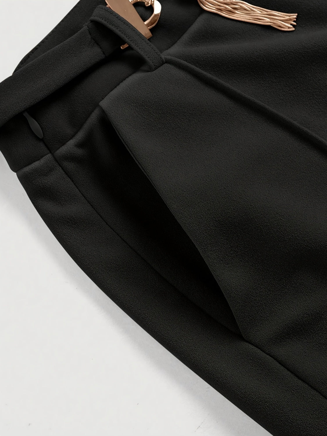 Black flared leg trousers with gold chain detail and pocket.