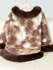 Faux fur trimmed camo poncho in chocolate brown with a fuzzy texture and a relaxed fit.