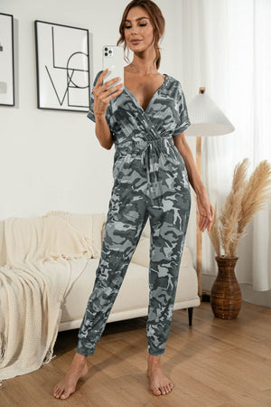 Gray camouflage print surplice waist jumpsuit with drawstring and short sleeves.