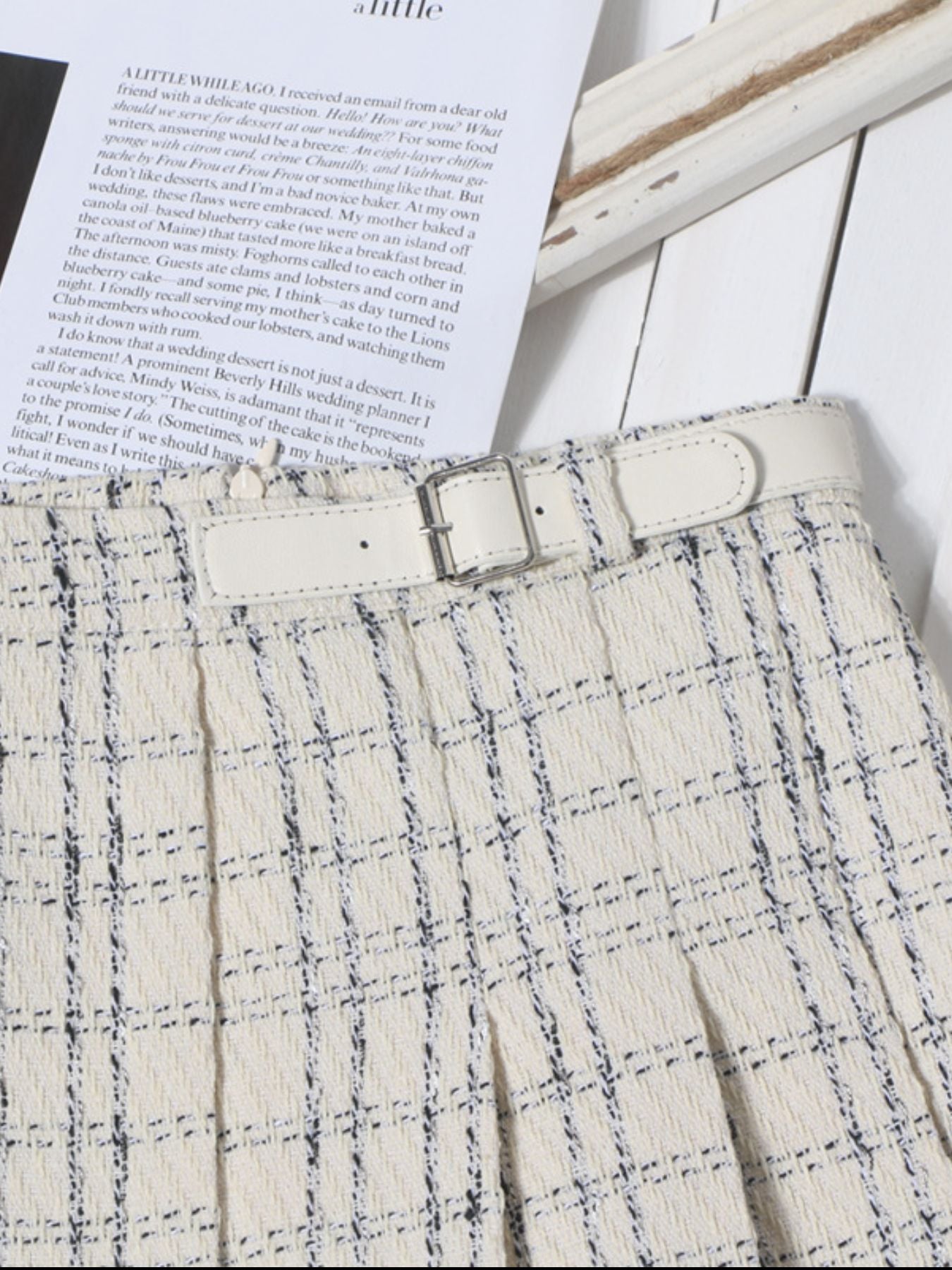 Beige plaid mini skirt with pleats and a white belt detail