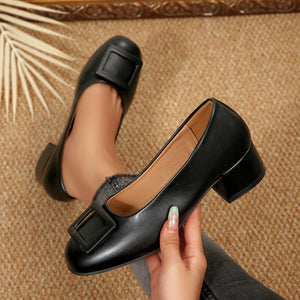 Black buckle block heel shoes with a square toe.