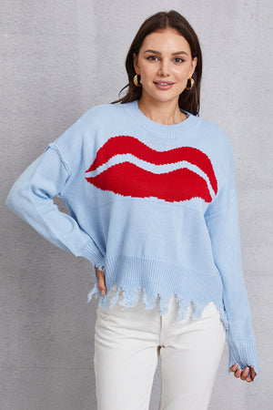 Light blue acrylic knit sweater with red kiss graphic and distressed hem.