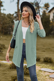 Sage textured open-front cardigan with pockets and long sleeves.
