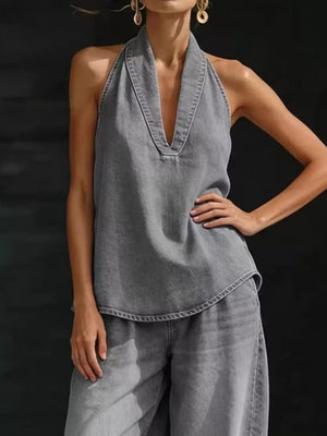 Gray denim halter neck top with deep V-neck and matching wide-leg pants.