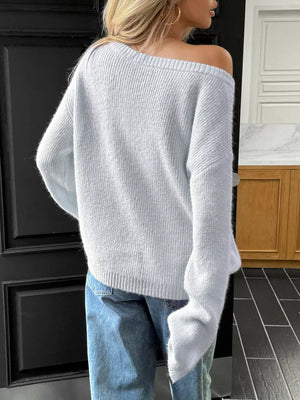 Light blue ribbed knit one-shoulder sweater with relaxed fit and long sleeves.