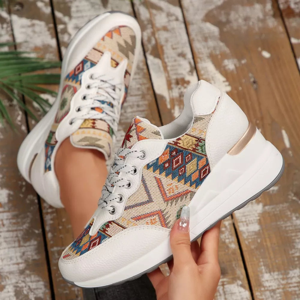 White leather wedge sneakers with colorful geometric pattern fabric and chunky sole.