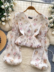 White floral chiffon blouse with balloon sleeves and peplum hem