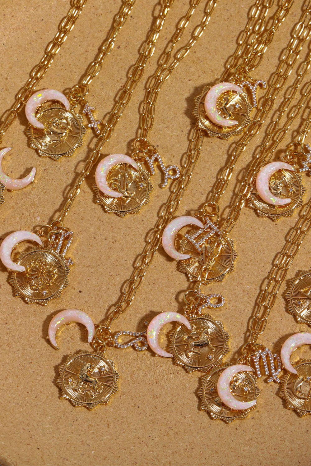Gold zodiac pendant necklaces with opal crescent moons and diamond accents.