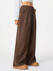 Brown corduroy maternity cargo pants with wide legs and drawstring waist.