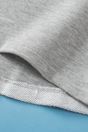 Light gray sweatshirt with a pocket detail and ribbed hem.