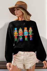 Black knit sweater with sequin nutcracker embellishment and balloon sleeves.