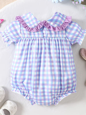 Baby one-piece with purple and blue gingham, ruffle collar, and puff sleeves.