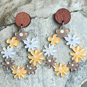 Floral wreath dangle earrings with wood tops and colorful daisy charms.