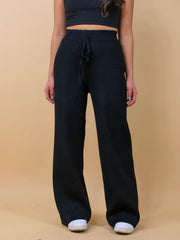 Black ribbed knit palazzo trousers with drawstring waist and wide leg