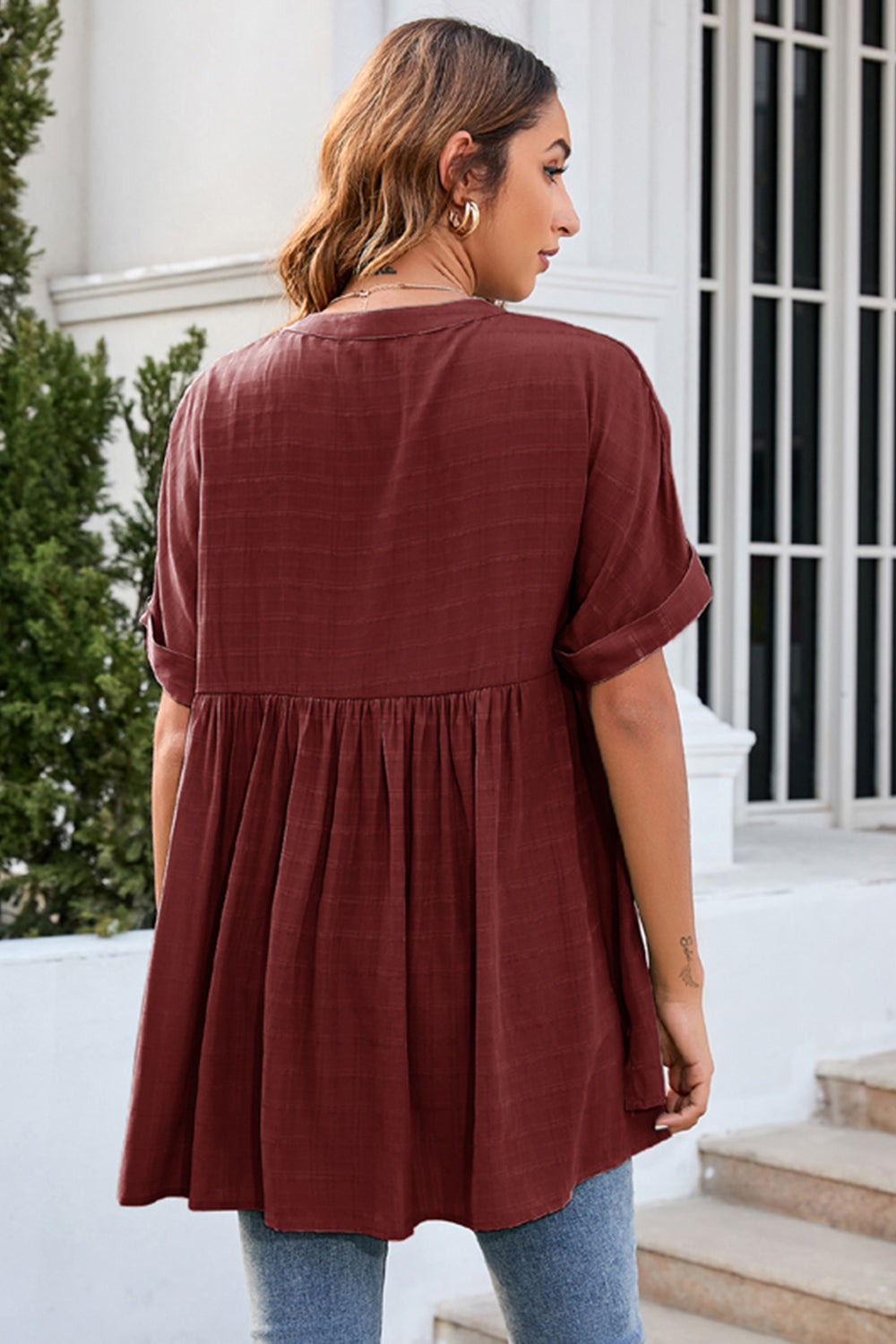 Burgundy gathered back yoke blouse with rolled sleeves and a flowy babydoll cut.