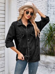 Black oversized denim trucker jacket with rolled sleeves and button front.
