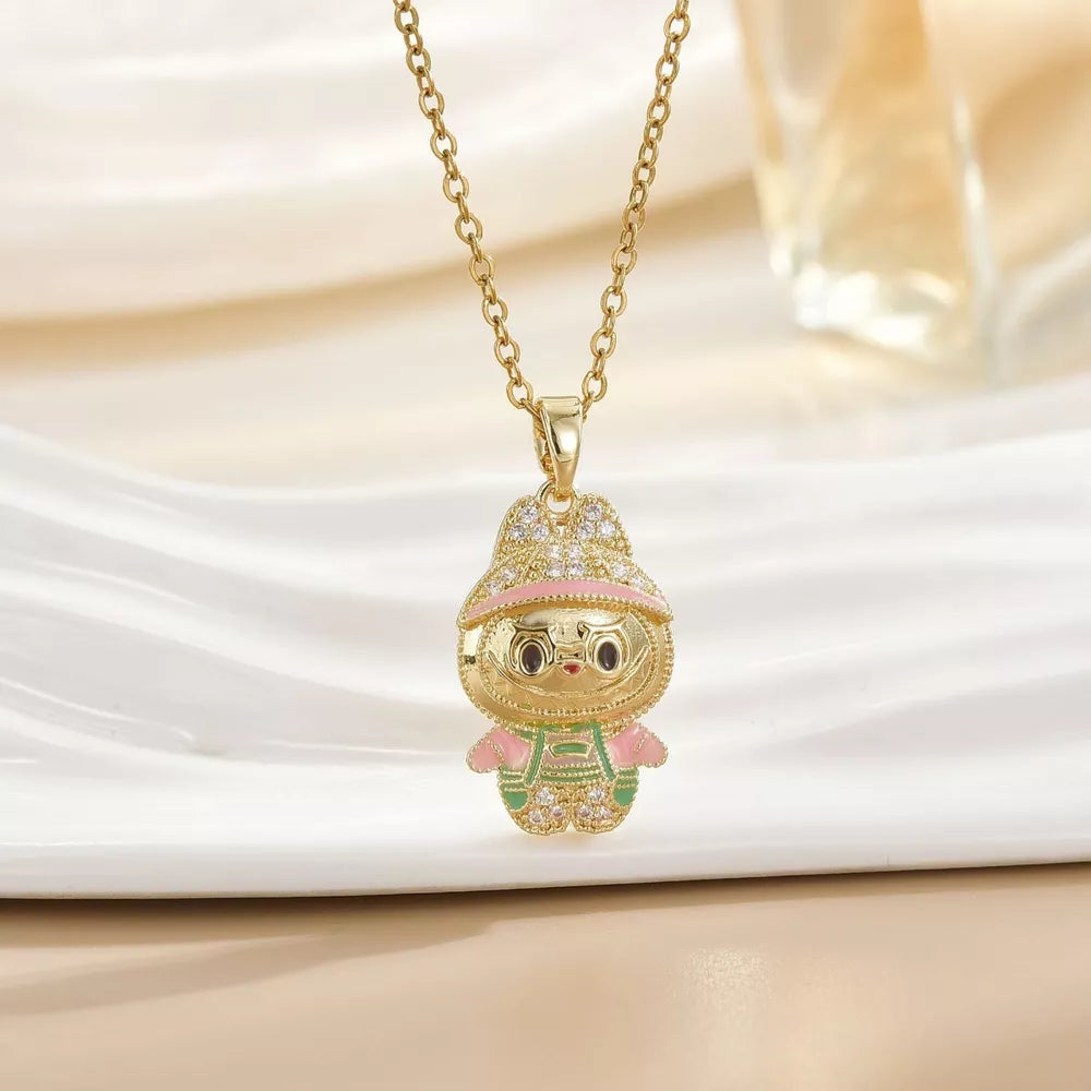 Gold-plated character pendant necklace with pink and green enamel details and crystal accents