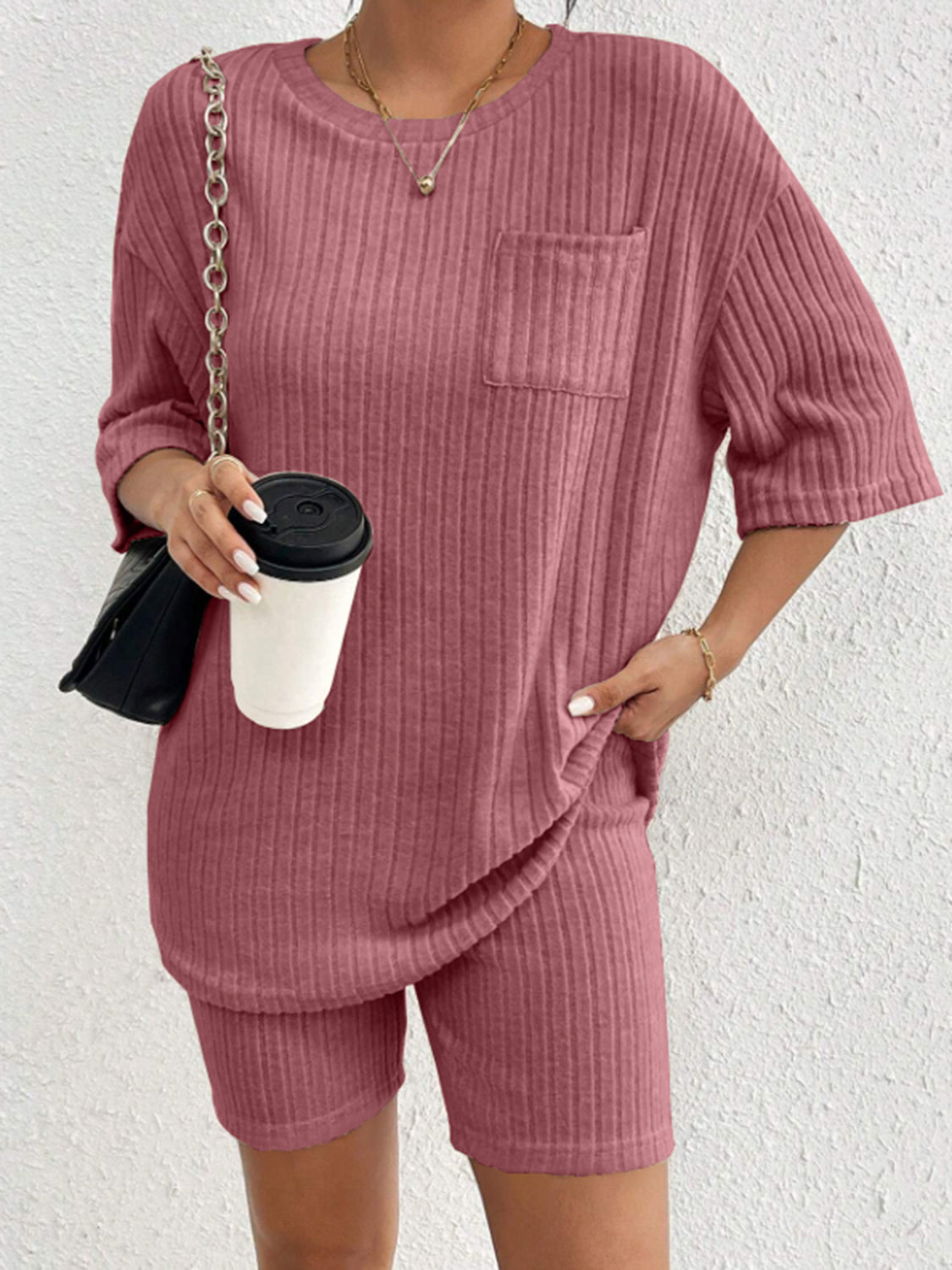 Relaxed ribbed lounge set in Dusty Pink with crew neck top and shorts, featuring a chest pocket.